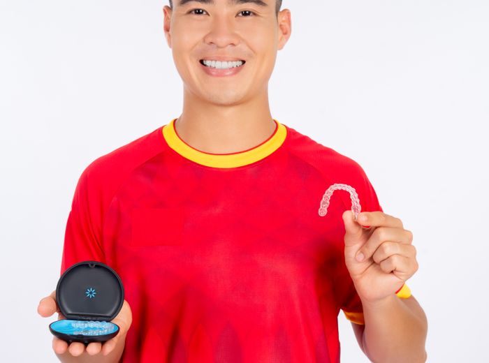 Happy man holding a clear aligner and its case